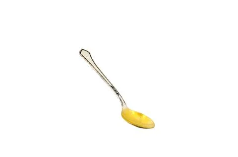 Empty silver desert spoon focus on bowl isolated on white. Foto stock