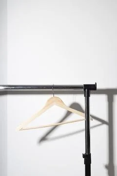 Empty single clothes hanger on plain. Conscious consumption slow fashion concept Stock Photos