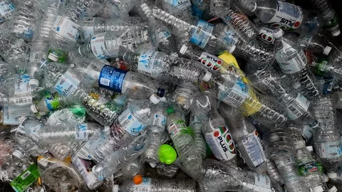 Empty single use plastic drink bottles in recycling pile Stock Footage