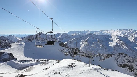 Empty ski lift elevator in winter snowy mountains in sunny day Stock Footage 98099434