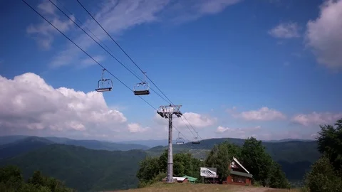 Empty ski resort in summer underneath ski lifts at top of mountain at summer Stock Footage 85362546