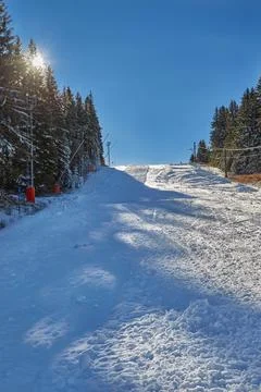 Empty ski slope with sun rays Stock Photos