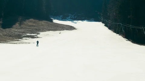 Empty ski track in spring resort. One person. Shot on RED Raven Stock Footage 105746231