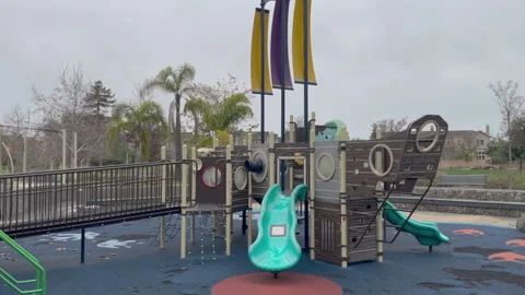 An Empty Slides in a Children's Park on A Cloudy Day Video stock 230192291