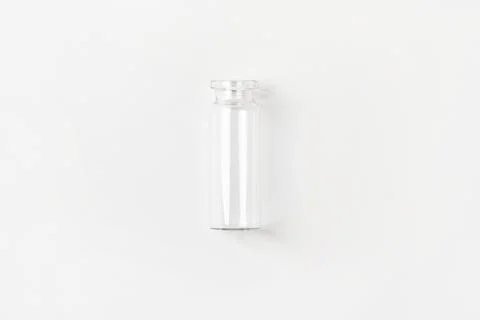 Empty small glass jar on a light background. View from above. Stock Photos