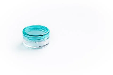 Empty small plastic or glass jar for beauty cream on white background. Acryli Stock Photos