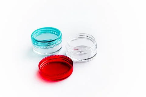 Empty small plastic or glass jar for beauty cream on white background. Acryli Stock Photos