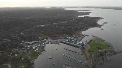 Empty Small Town Harbour and Rocky Coastal Landscape, Aerial Reveal Stock Footage 145396098
