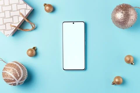 Empty smartphone screen with decorations on blue background from above. Chris Stock Photos