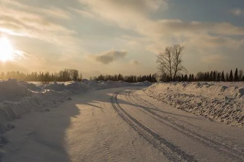 Empty snow covered road in winter landscape. Stock Photos