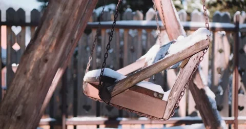Empty Snow-Covered Swing in Sunny Winter Garden. 4K DCi SLOW MOTION 120 fps. Stock Footage 67217283