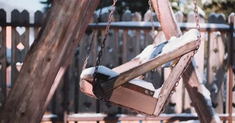 Empty Snow-Covered Swing in Sunny Winter Garden. 4K DCi SLOW MOTION 120 fps. Stock Footage 67217715