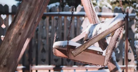 Empty Snow-Covered Swing in Sunny Winter Garden. 4K DCi SLOW MOTION 120 fps. Stock Footage 67218344