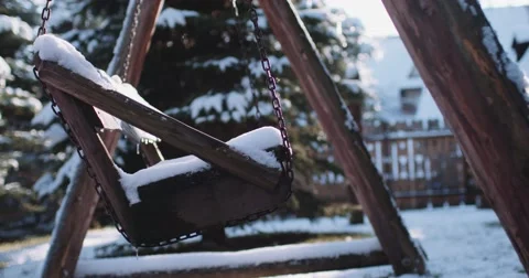 Empty Snow-Covered Swing in Sunny Winter Garden. 4K DCi SLOW MOTION 120 fps. Stock Footage 67218433