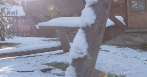 Empty Snow-Covered Swing in Sunny Winter Garden. 4K DCi SLOW MOTION 120 fps. Stock Footage 67218941