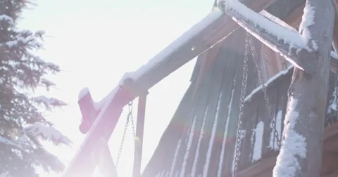 Empty Snow-Covered Swing in Sunny Winter Garden. 4K DCi SLOW MOTION 120 fps. Stock Footage 67219463