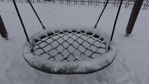 Empty snowy swing in winter  playground Stock Footage 122741135
