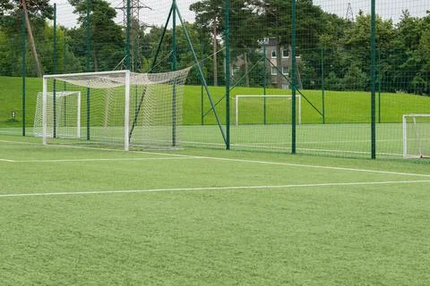 Empty soccer field with goal nets. Outdoor football pitch on a green grass .. Photos