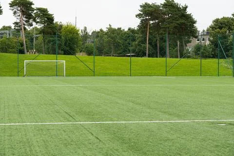 Empty soccer field with goal post. Green artificial turf pitch for football.. Stock Photos