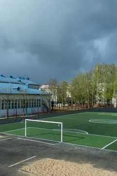 Empty soccer field with green artificial turf and white goals at school sta.. Stock Photos