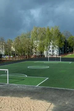 Empty soccer field with green artificial turf and white goals at school sta.. Stock Photos