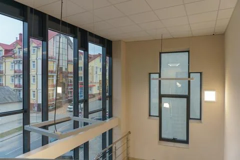 An empty space with railings and large windows. The modern interior of the lo Stock Photos