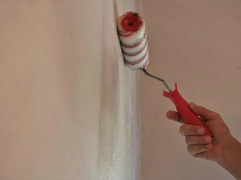 Empty space on the wall with a picture of a hand with a roller Stock Photos