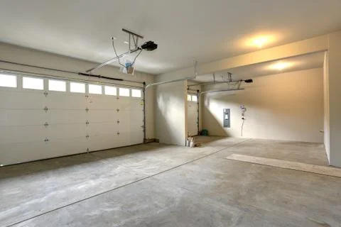 Empty spacious garage interior with cream walls paint color and concrete floo Stock Photos