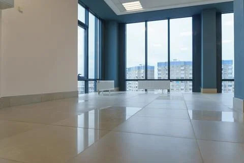 An empty spacious room of a modern office building with large windows. An emp Stock Photos