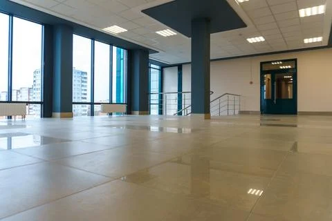 An empty spacious room of a modern office building with large windows. An emp Stock Photos