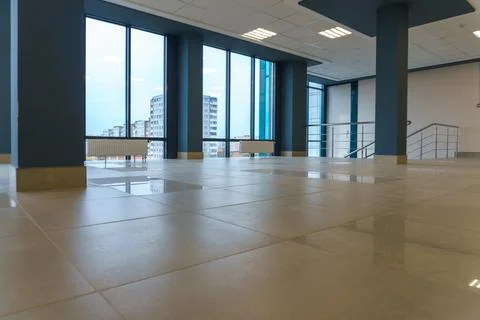 An empty spacious room of a modern office building with large windows. An emp Stock Photos