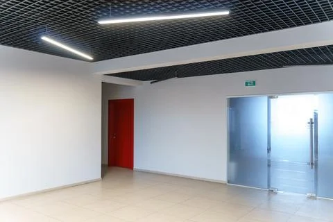 An empty spacious room of a modern office building with large windows. An emp Stock Photos
