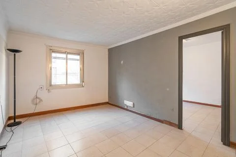 Empty spacious room with window and dirty walls in an old flat before renovation Stock Photos