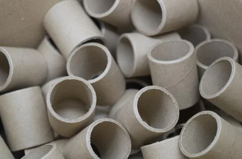 Empty spools in bulk in a box. Reels with a diameter of 40 mm for winding paper Stock Photos