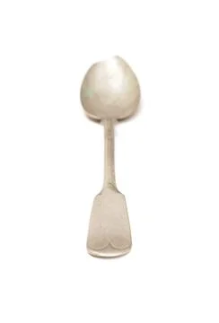 Empty spoon, old used silverware on a white table, selective focus on foreground Stock Photos