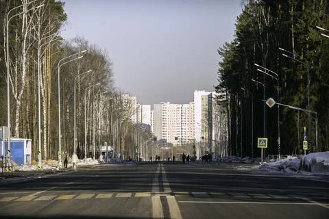 Empty spring road with pedestrians Stock Photos