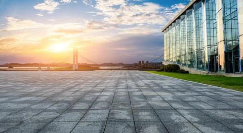 Empty square floor and bridge with urban skyline at sunset in Zhoushan Stock Photos