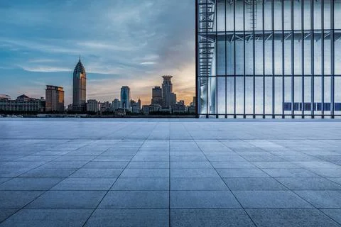 Empty square floor and city skyline with buildings in Shanghai at sunset. Stock Photos