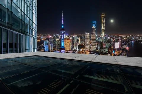 Empty square floor and city skyline with buildings in Shanghai at night. Stock Photos