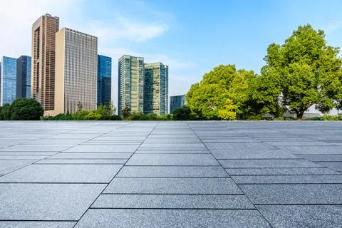 Empty square floor and city skyline with modern commercial buildings. Stock Photos