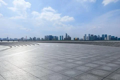 Empty square floor and city skyline with modern commercial buildings. Stock Photos