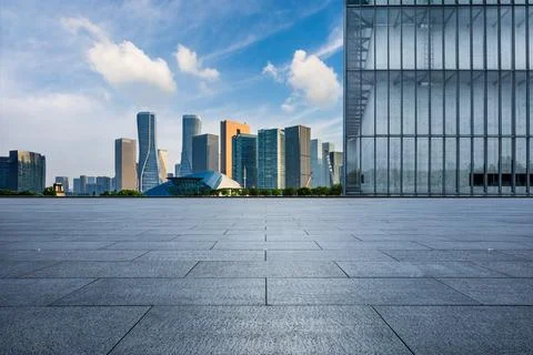 Empty square floor and city skyline with modern commercial buildings. Stock Photos