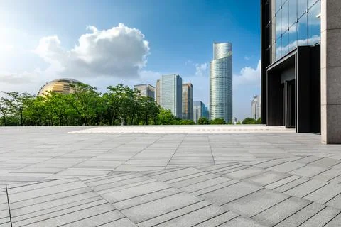 Empty square floor and city skyline with modern commercial buildings. Stock Photos
