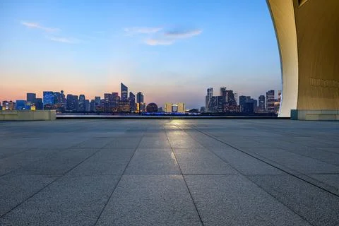 Empty square floor and city skyline with modern commercial buildings. Stock Photos