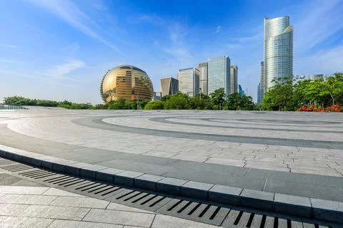 Empty square floor and city skyline with modern commercial buildings. Stock Photos