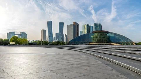 Empty square floor and city skyline with modern commercial buildings. Stock Photos