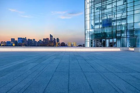 Empty square floor and city skyline with modern commercial buildings. Stock Photos