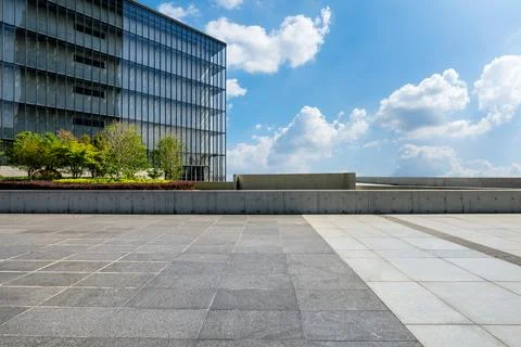 Empty square floor and city skyline with modern commercial buildings. Stock Photos
