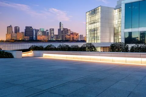 Empty square floor and city skyline with modern commercial buildings. Stock Photos