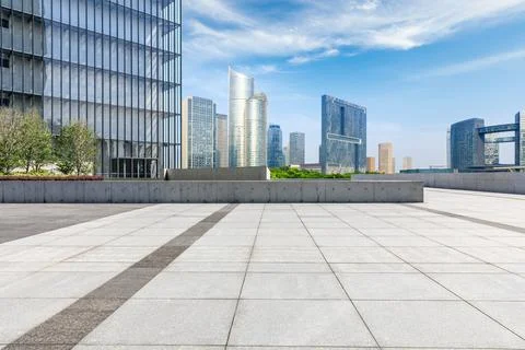 Empty square floor and city skyline with modern commercial buildings. Stock Photos